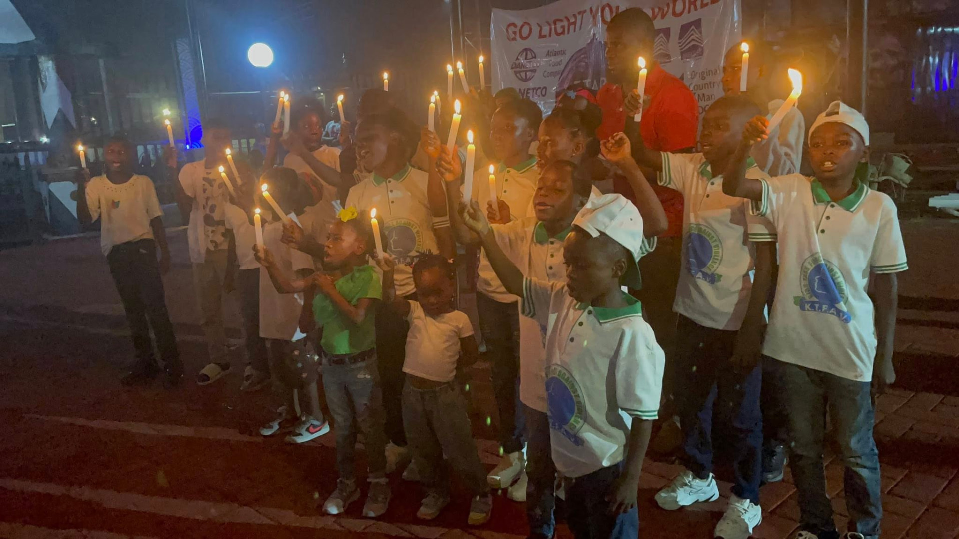 Children holding candles during a Stars Ablaze 'Go Light Your World' community outreach event