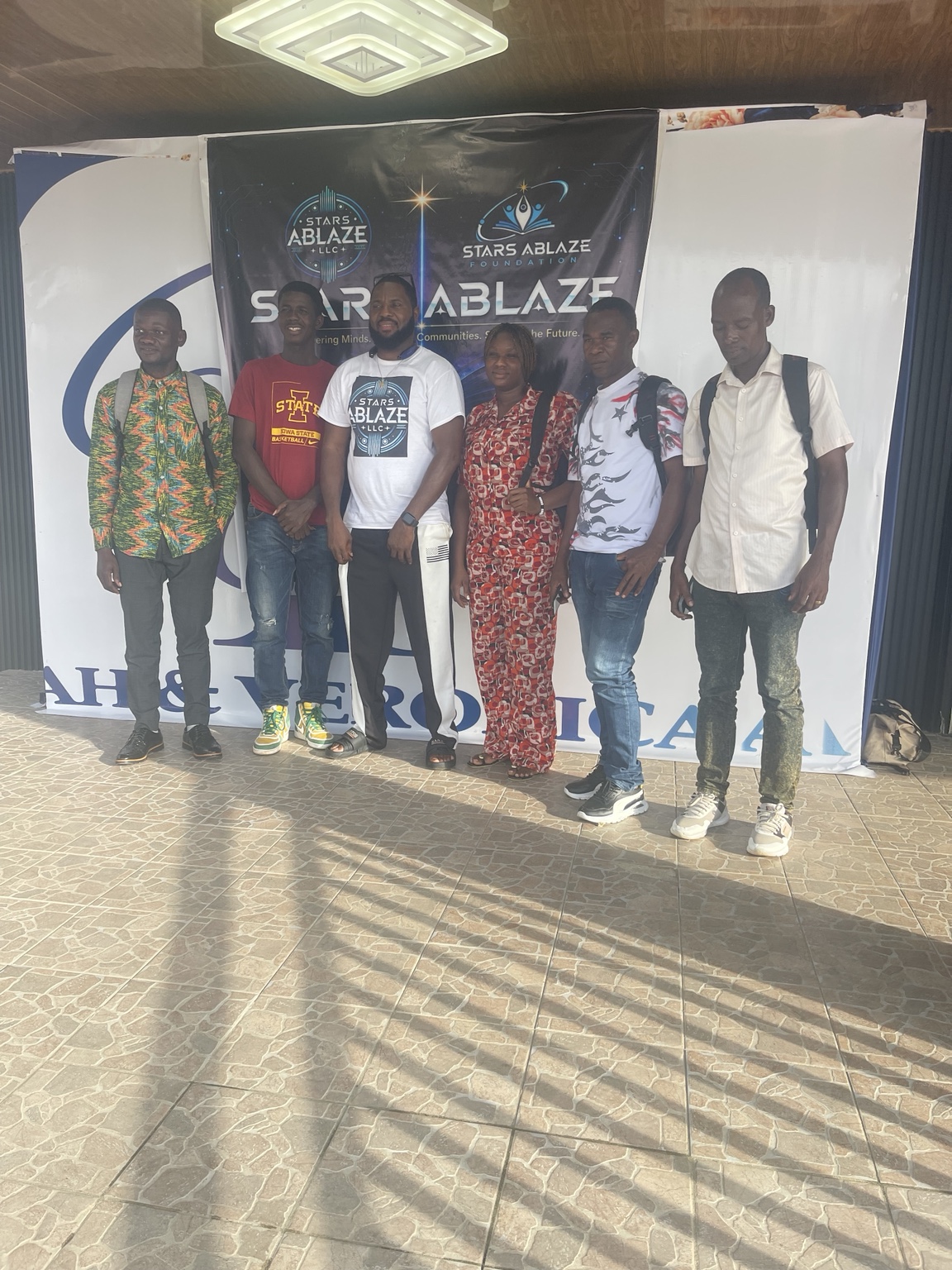 Participants posing in front of the Stars Ablaze LLC and Foundation backdrop