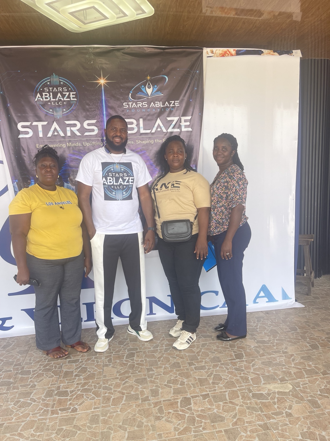 Training team and participants in front of the Stars Ablaze banner