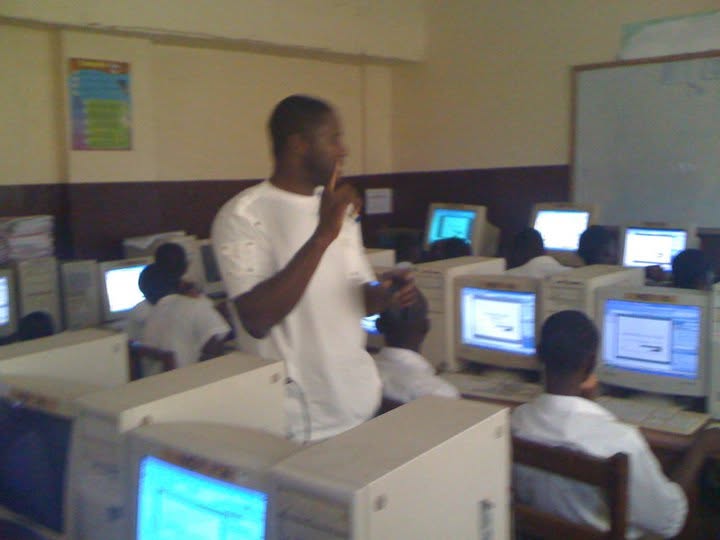 Teacher instructing students in a computer lab during digital skills outreach